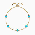 The 14K Yellow Gold Turquoise and Diamond Station Bolo Bracelet features evenly spaced round turquoise stones and sparkling diamonds, finished with an adjustable sliding clasp adorned with small gold beads.