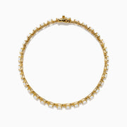 The 14K Yellow Gold Opal and Diamond Tennis Bracelet features a row of round white opals set in gold prongs, accented with diamonds, displayed on a white background.