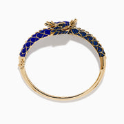 The 14K Yellow Gold Lapis, Blue Sapphire and Diamond Dragon Bangle features two dragon heads facing each other, with a blue enamel scale-inspired band, intricate gold details, and blue sapphire accents.