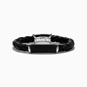 The Mens 925 Sterling Silver Spinel Leather Bracelet features black braided leather, a shiny sterling silver clasp, and a rectangular silver accent with sparkling black spinels, displayed against a white background.