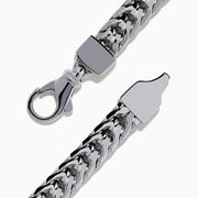 The Mens Sterling Silver Black Spinel Bracelet features a woven chain, a rectangular textured black spinel centerpiece, and a secure clasp closure, shown on a white background.