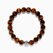 The Tiger's Eye and Onyx Beaded 2-Piece Bracelet Set with Sterling Silver features brown and black beads, each bracelet accented by a single sterling silver bead with a textured, woven pattern for an elegant stacked look.