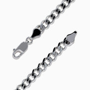 The Mens 925 Sterling Silver Chain Link Blue Sapphire Bracelet features a rectangular bar centerpiece adorned with blue sapphires, showcased elegantly on a white background.