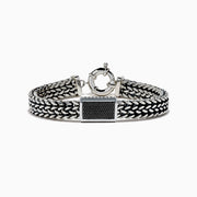 The Men's 925 Sterling Silver Black Spinel Chain-Link Bracelet features black and silver woven links, a rectangular clasp accented with black spinel stones, and a round spring-ring closure at the top.