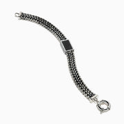 The Men's 925 Sterling Silver Black Spinel Chain-Link Bracelet features black and silver woven links, a rectangular clasp accented with black spinel stones, and a round spring-ring closure at the top.