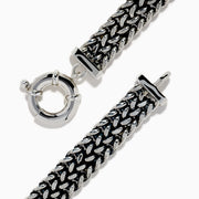 The Men's 925 Sterling Silver Black Spinel Chain-Link Bracelet features black and silver woven links, a rectangular clasp accented with black spinel stones, and a round spring-ring closure at the top.