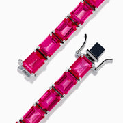 The 925 Sterling Silver Pink Topaz Tennis Bracelet features vibrant rectangular pink topaz gemstones set in individual prongs, forming a continuous elegant line.