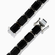 The 925 Sterling Silver Onyx Tennis Bracelet features rectangular black onyx stones in a sleek silver link design, shown on a white background—an elegant accessory for any occasion.
