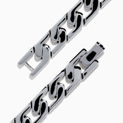 The 925 Sterling Silver Sapphire Bracelet features chain links and a rectangular centerpiece with small blue gemstones, evoking the look of sapphires, and is shown on a white background.
