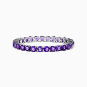 The 925 Sterling Silver Purple Amethyst Bracelet is shown on a plain white background, featuring faceted round amethyst gemstones in a classic tennis style.