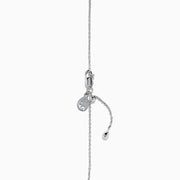 The Ocean Bleu 14K White Gold Blue Topaz and Diamond Bolo Bracelet features a delicate chain, a central round blue topaz, sparkling diamonds, and an adjustable clasp with a small charm near the closure.