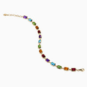 The Mosaic 14K Yellow Gold Bezel Multi Color Gemstone Bracelet showcases blue, green, purple, red, and amber rectangular stones evenly spaced along a delicate chain with an adjustable clasp.