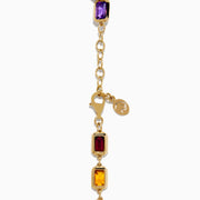 The Mosaic 14K Yellow Gold Bezel Multi Color Gemstone Bracelet showcases blue, green, purple, red, and amber rectangular stones evenly spaced along a delicate chain with an adjustable clasp.