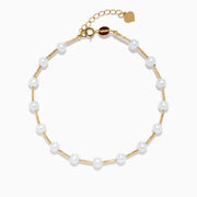 The 14K Yellow Gold Fresh Water Pearl Station Bracelet features a delicate design with evenly spaced pearls and a gold lobster clasp, displayed on a plain white background.