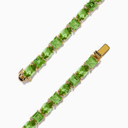 The 14K Yellow Gold Peridot Tennis Bracelet 13.50 TCW features evenly spaced round and square green gems, shown against a white background.