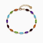 The Mosaic 14K Yellow Gold Multi Gemstone Adjustable Tennis Bracelet (9.30 TCW) features oval, faceted blue, green, purple, orange, and red stones set along a delicate yellow gold chain with an adjustable clasp.