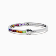The 925 Sterling Silver Baguette Multi Color Gemstone Bangle showcases a row of vibrant rainbow-hued gemstones set along the front.