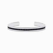 A sleek Mens 925 Sterling Silver Black Sapphire Cuff Bangle (4.09 TCW) features a single row of dark sapphires along the center, an open-ended design, polished finish, and modern appeal.
