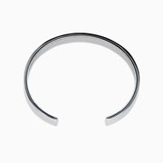 The Men's 925 Sterling Silver and Blue Sapphire Bracelet features a row of blue sapphires at the center and black chevron accents on the edges, offering a bold update to the classic blue sapphire bracelet.