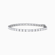 A Lab Grown Emerald Cut Diamond 7.50ct Tennis Bracelet in 14K White Gold is shown, featuring a continuous row of rectangular lab grown diamonds on a plain white background.