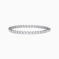 The Lab Grown Round Diamond 5.00ct Cupcake Setting Tennis Bracelet in 14K White Gold features a slender band adorned with a continuous row of sparkling lab grown diamonds.