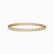 The Lab Grown Round Diamond 5.00ct Cupcake Setting Tennis Bracelet in 14K Yellow Gold features a single row of prong-set lab grown diamonds, shown against a white background.