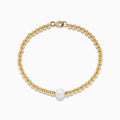 The 14K Yellow Gold Cultured Fresh Water Pearl Beaded Bracelet features a circular design with a central freshwater pearl and secures with a lobster clasp.