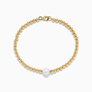 The 14K Yellow Gold Cultured Fresh Water Pearl Beaded Bracelet features a circular design with a central freshwater pearl and secures with a lobster clasp.