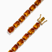 The Sunset 14K Yellow Gold Radiant Cut Citrine Tennis Bracelet showcases rectangular, faceted amber-hued gemstones in individual prong settings along a classic yellow gold chain.