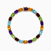The 14K Yellow Gold Radiant Cut Multi Color Gemstone Tennis Bracelet showcases a continuous line of rectangular purple, red, blue, green, and yellow stones.