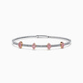 The 14K Two-Tone Gold Pink and White Diamond Bangle features a delicate band with pink and white diamonds, including five marquise-shaped pink diamond clusters set in rose gold.