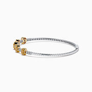 The Canare Platinum and 18K Yellow Gold Yellow and White Diamond Bangle features five oval yellow gold accents, each set with yellow diamonds, spaced along clear square-cut white diamonds for a sleek, elegant look.