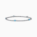 The Lab Grown Blue and White Diamond Tennis Station Bracelet in 14K white gold features clear lab grown diamonds with three evenly spaced round blue gemstones, shown displayed on a white background.