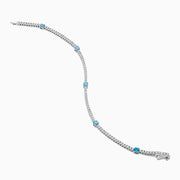 The Lab Grown Blue and White Diamond Tennis Station Bracelet in 14K white gold features clear lab grown diamonds with three evenly spaced round blue gemstones, shown displayed on a white background.