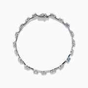 The Lab Grown Blue and White Diamond Multi Shape Tennis Bracelet in 14K White Gold showcases alternating oval, round, and emerald-cut lab-grown blue and white diamonds against a white background.