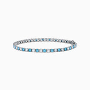 The Lab Grown Blue and White Diamond Tennis Bracelet in 14K White Gold features alternating round blue and white diamonds set in a continuous line, shown against a white background.