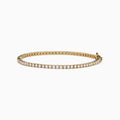 The Lab Grown Diamond 2.95ct Tennis Bracelet in 14K Yellow Gold showcases a continuous line of round lab grown diamonds in prong settings, beautifully displayed against a plain white background.