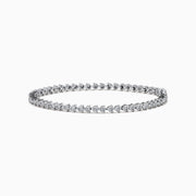 The 14K White Gold Diamond Miracle Setting Tennis Bracelet features a continuous line of round-cut diamonds set in white gold, displayed against a plain white background.