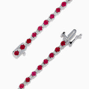 The 925 Sterling Silver Ruby and Diamond Tennis Bracelet features a continuous row of round rubies and diamonds set in individual prongs, forming an elegant circle for timeless sophistication.