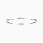 The 14K White Gold Bezel Diamond Bezel Bracelet features five round diamond-like stones in bezel settings, evenly spaced along a delicate chain, and secured with a lobster clasp.