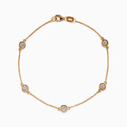 The Pave Rose 14K Rose Gold Diamond Station Bracelet features five round diamonds in gold bezels on a delicate chain with a lobster clasp, shown on a white background.