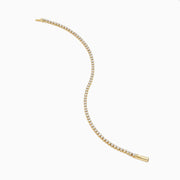 The 14K Yellow Gold Diamond Tennis Bracelet 2.33TCW, featuring a continuous row of sparkling round white diamonds, is elegantly shown on a simple white background.