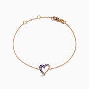 The 14K Rose Gold Multi Sapphire Heart Bracelet features a heart-shaped pendant with small purple sapphires, displayed on a white background.