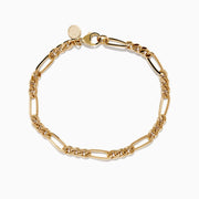 The Mens 14K Yellow Gold Figaro Chain Bracelet features elongated, interlocking links and a small round charm near the clasp, displayed on a white background.