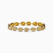 The Canare 18K Yellow Gold Yellow and White Diamond Bracelet features alternating teardrop and oval links with yellow gemstones accented by white diamonds, shown on a white background.