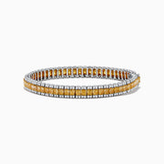 The Canare 18K Two Tone Gold White & Yellow Diamond Bracelet, showcasing a central row of yellow diamonds bordered by clear stones, is elegantly displayed on a white background.