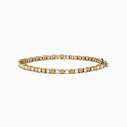 The Canare 18K White and Yellow Gold Diamond Tennis Bracelet features alternating white and yellow diamonds, elegantly displayed in a circular shape on a white background.