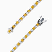 The Canare 18K White and Yellow Gold Diamond Tennis Bracelet features alternating white and yellow diamonds, elegantly displayed in a circular shape on a white background.