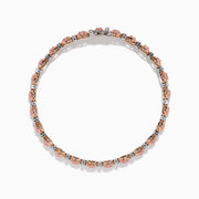 The 18K Two Tone White & Pink Diamond Bracelet features alternating clusters of pink and white diamonds in a repeating pattern around the entire band, beautifully set against a white background.