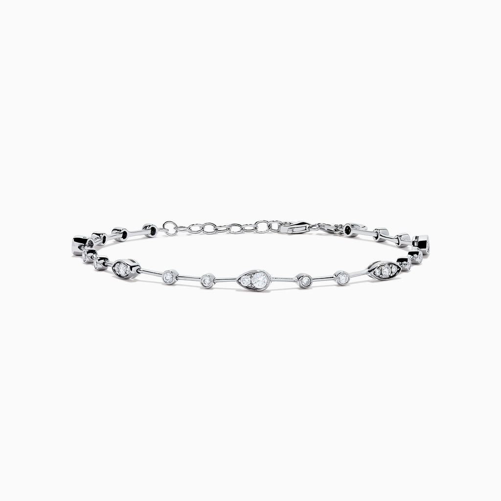 The 14K White Gold Diamond Station Bracelet features small round and teardrop-shaped diamonds spaced along a thin chain, showcased on a white background.